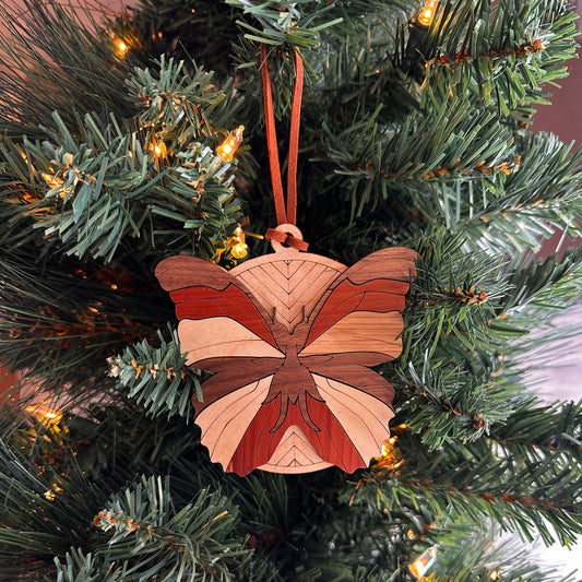 Layered wooden  butterfly  ornament made with multiple species of wood. 