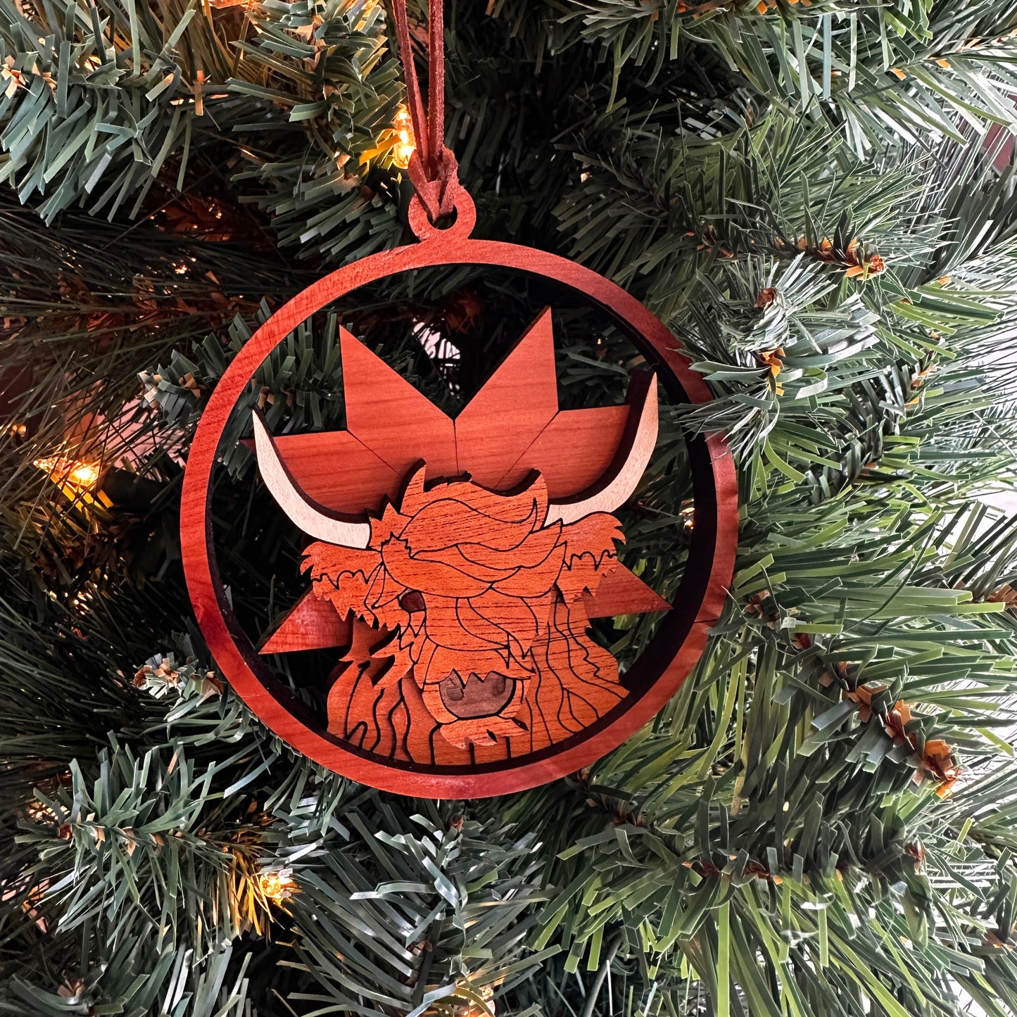Layered wooden  highland cow ornament made with multiple species of wood. 