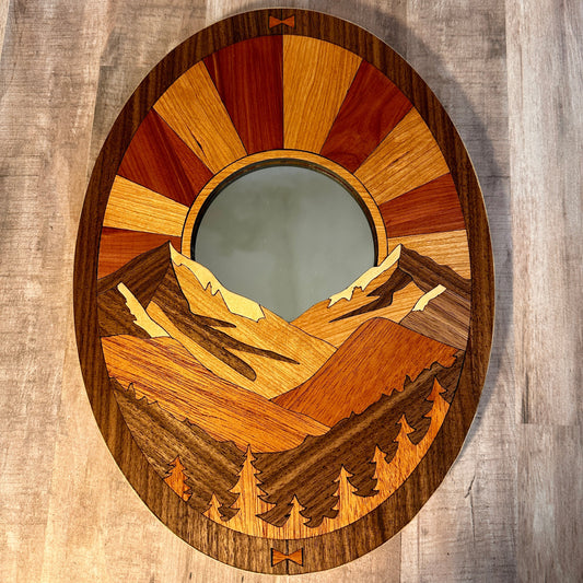 Wooden wall art with mountain design on a wooden background