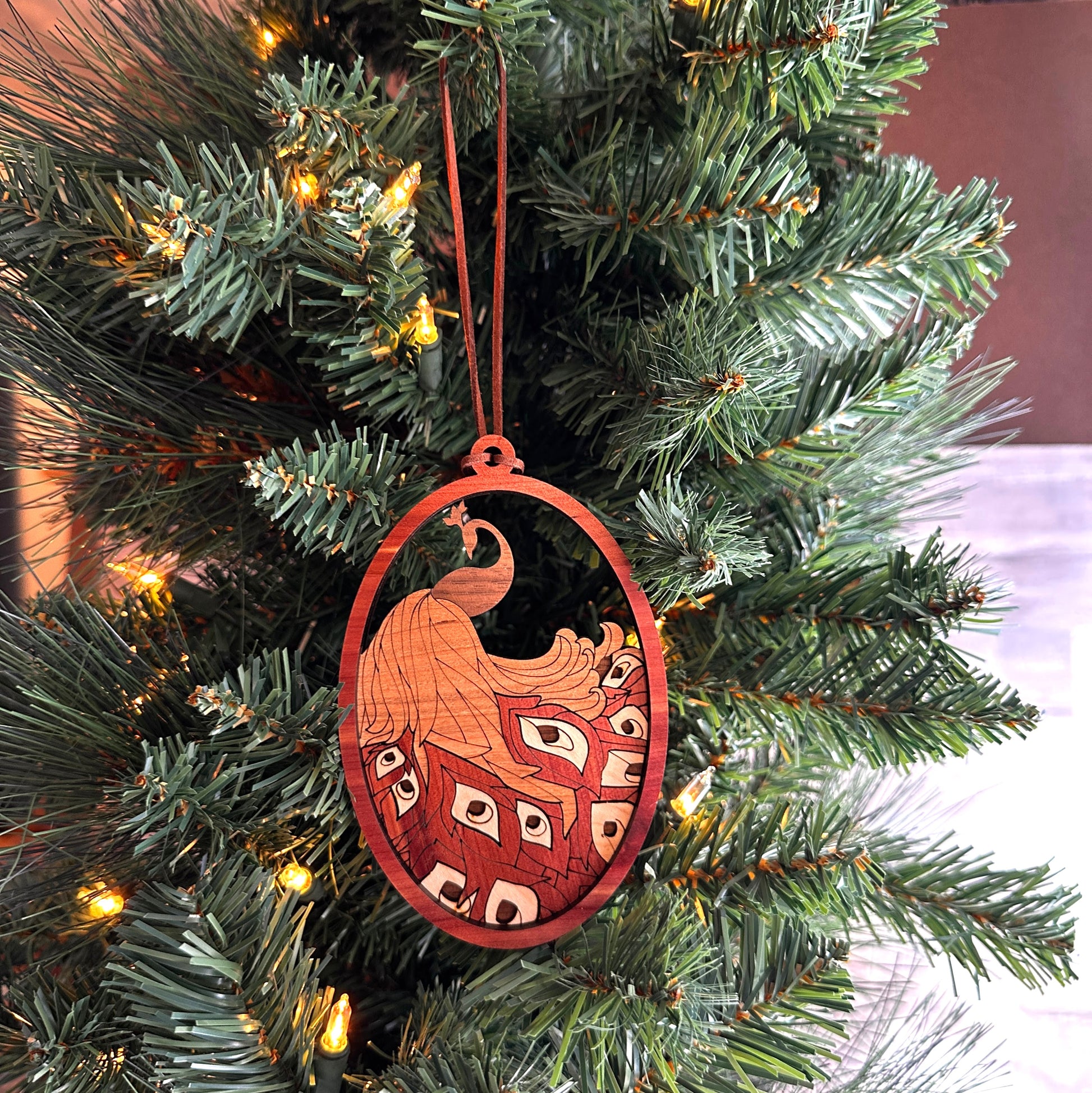 Layered wooden  peacock ornament made with multiple species of wood. 